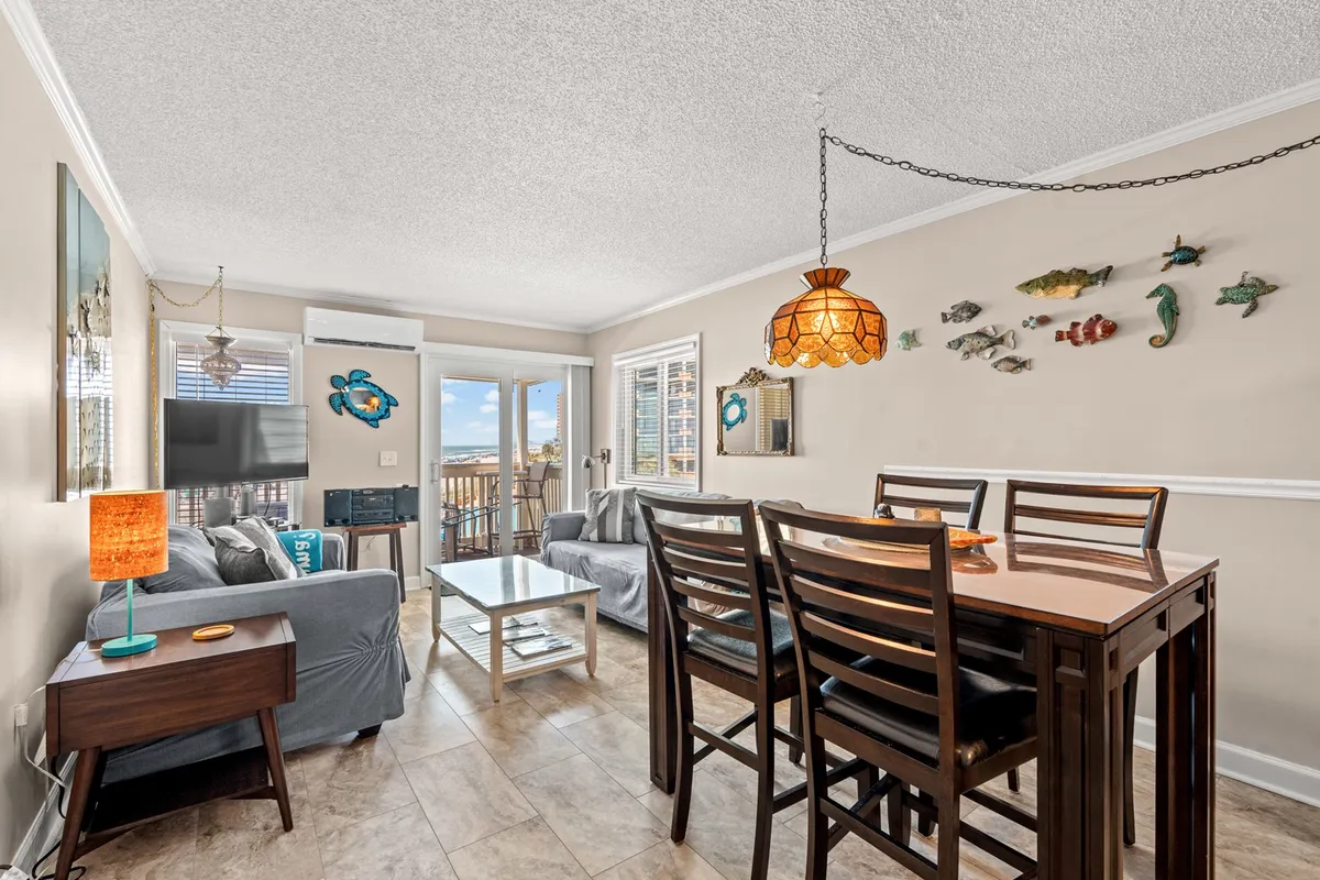 A combined living and dining area featuring a stylish dining table, cozy coffee table, decorative wall art, and a TV. The space exudes a sense of warmth and togetherness, ideal for family dinners, game nights, or movie evenings with loved ones.
